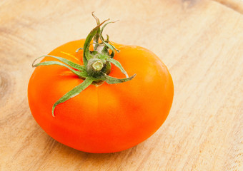 fresh red tomato on cutting board