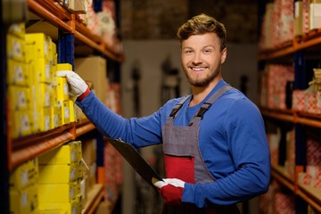 Poster - Worker on a automotive spare parts warehouse