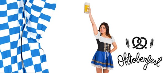 Wall Mural - Composite image of pretty oktoberfest girl raising beer tankard