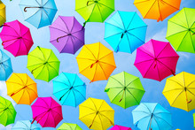 Hanging Multicolored Umbrellas Over Blue Sky