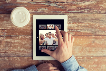 Poster - close up of male hands with photo on tablet pc