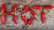 dried hot chili letters on old wooden table