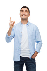 Wall Mural - smiling man pointing finger up