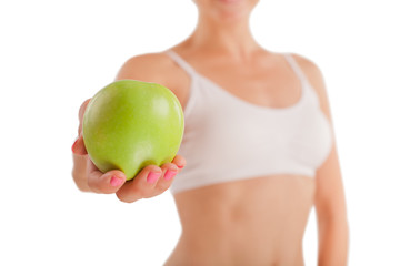 Wall Mural - Athletic girl with green apple.