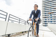 © Westend61 - Businessman riding bicycle