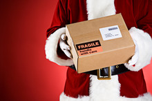 Santa: Holding A Package Ready For Shipping