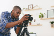 © Westend61 - Young man at work in his photographic studio