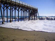 Waves Pound The Wooden Pier In California