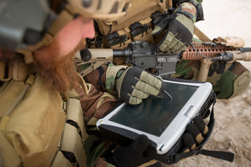 commander of the soldiers paves the route on an electronic table