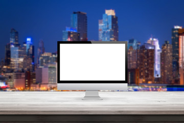 Poster - computer monitor on wooden desk city sky line lights in the background display mock up