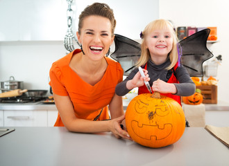 Sticker - Mother with halloween dressed daughter creating Jack-O-Lantern