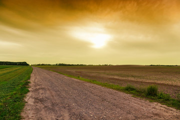 Canvas Print - Dirty road to dramatic sky