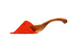 Powdered pimienta roja red pepper in the wooden spoon, isolated on white background.