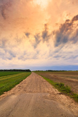 Poster - Dirty road to dramatic sky