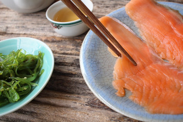 Wall Mural - Smoked salmon and seaweed salad with hot tea