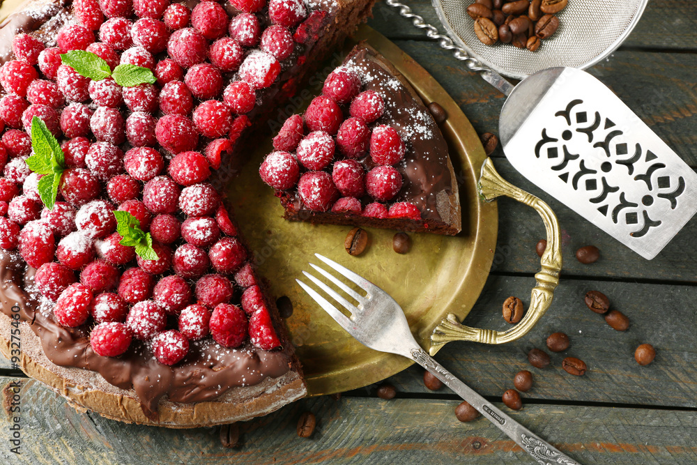 Cake with Chocolate Glaze and raspberries on wooden background