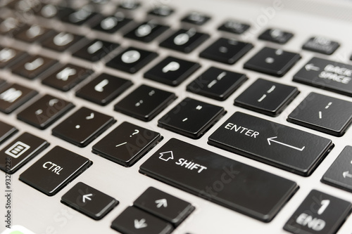 Fényképezés  Laptop computer keyboard close up with red enter key button