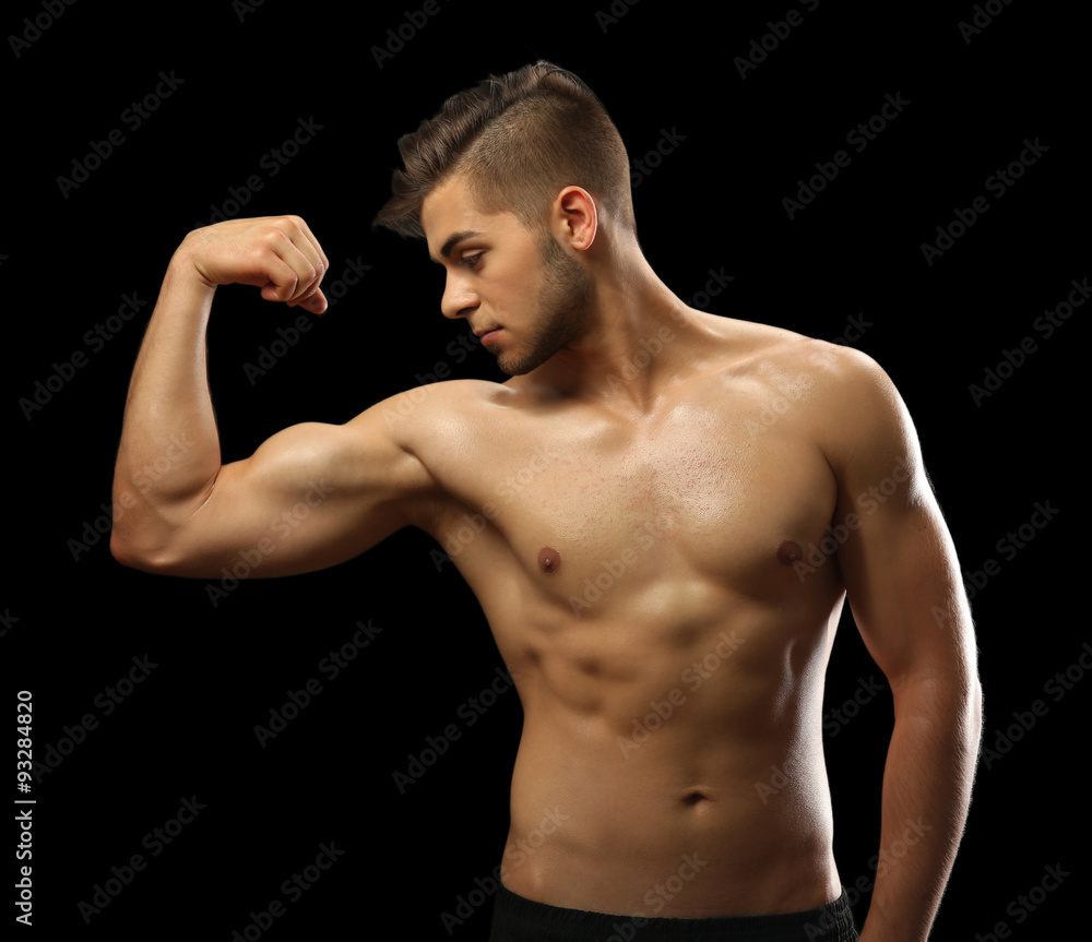 Muscle young man on dark background