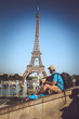 © Fxquadro - Tourist man in summer clothing over elfel tower.