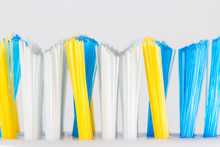 Macro Photo Of Colorful Toothbrush Bristles Isolated On A White Background.
