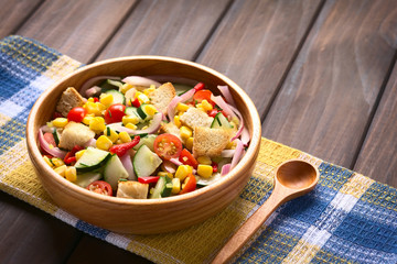 Wall Mural - Fresh vegetable salad of sweet corn, cherry tomato, cucumber, red onion, red pepper, chives with croutons, photographed with natural light (Selective Focus, Focus one third into salad)