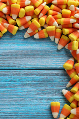 Halloween candy corns on blue wooden background