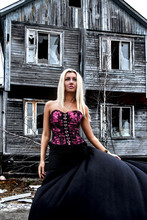 Woman At The Background Of The Abandoned House