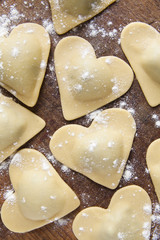 Wall Mural - fresh Italian ravioli in shape of heart. food background.