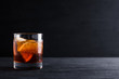 Old fashioned cocktail on the wooden background