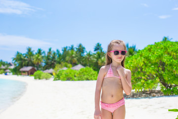 Wall Mural - Adorable little girl at beach during summer vacation