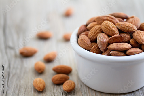 Cuadros en Lienzo Bowl of Almond Nuts on Rustic Wooden Table