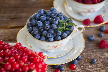 Wall Mural - red currant, raspberry and blueberry in cups 