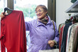 © DariaTrofimova - woman choosing   purchase in clothing store.
