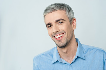 Wall Mural - Smiling young man posing to the camera