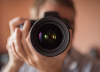 Photographer doing self portrait in a mirror. Vintage toning. Shallow depth of filed.