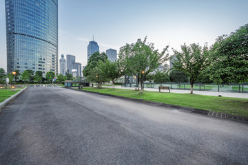 Wall Mural - asphalt road of a modern city with skyscrapers