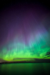 Wall Mural - northern lights over lake in finland
