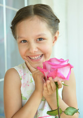 Wall Mural - little girl with rose flower.