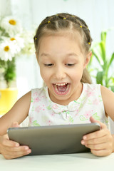 Wall Mural - beautiful little girl with table pc