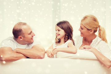 Poster - smiling parents and little girl at home