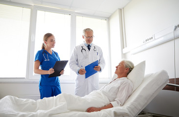 Wall Mural - doctor and nurse visiting senior woman at hospital