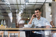 © sutulastock - Businessman in a cafe talking on the phone