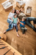 © jackfrog - a family laying in their new flat with cardboard boxes