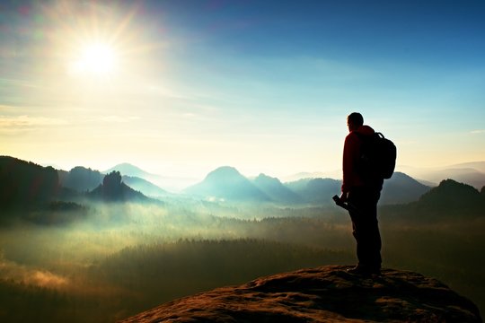 The photographer think about picture at sunset in the misty mountains