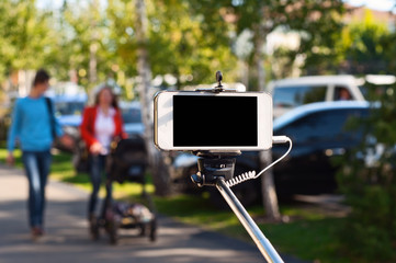 white phone in selfie stick