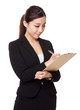 © leungchopan - Asian Young businesswoman take note on clipboard
