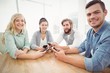 © WavebreakMediaMicro - Portrait of smiling business people using smartphones