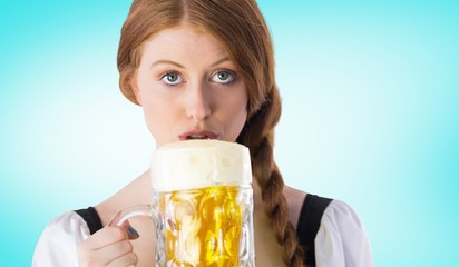 Wall Mural - Composite image of oktoberfest girl drinking jug of beer