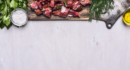 border with Fresh raw sliced lamb meat cleaver oil salt herbs on white wooden rustic background banner for website  space for text