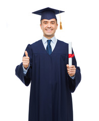 smiling adult student in mortarboard with diploma